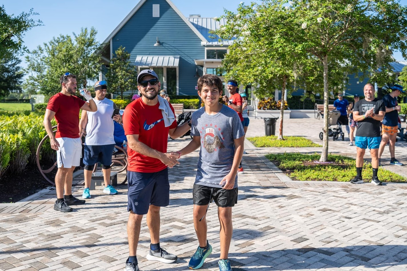 Pablo Luna with a young runner at a community race